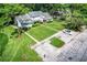 Charming front exterior view with a well-maintained lawn, mature trees, and ample parking space at 1624 Rivers Edge Dr, Orlando, FL 32825