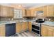 Bright kitchen featuring wood cabinets, granite countertops, stainless steel appliances, and a mosaic backsplash at 1624 Rivers Edge Dr, Orlando, FL 32825