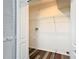 Spacious laundry room with ample shelving and new flooring, providing convenience for household tasks at 1624 Rivers Edge Dr, Orlando, FL 32825