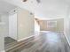 Bright living room boasts modern flooring, staircase, and a view of the front yard through a window at 1624 Rivers Edge Dr, Orlando, FL 32825