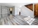 Bright living room features modern flooring, staircase, neutral walls, and sliding glass doors to the patio at 1624 Rivers Edge Dr, Orlando, FL 32825