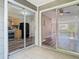 Back patio view through sliding glass doors to kitchen and open living room at 1624 Rivers Edge Dr, Orlando, FL 32825