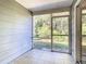 Screened porch with tile flooring overlooks the lush, green backyard and mature trees at 1624 Rivers Edge Dr, Orlando, FL 32825