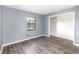 Bedroom features gray walls, wood-look floors, and closet at 6682 Sw 106Th Ln, Ocala, FL 34476