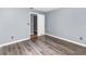 Bedroom with gray walls, wood floors, and open doorway at 6682 Sw 106Th Ln, Ocala, FL 34476