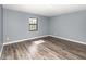 Bedroom with a gray paint job, new floors, and a window that offers natural light at 6682 Sw 106Th Ln, Ocala, FL 34476