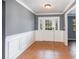 Inviting foyer with decorative molding, tile flooring, and a classic front door with sidelights at 6682 Sw 106Th Ln, Ocala, FL 34476
