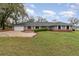 Charming single-story home featuring a brick facade, lush lawn, and a two-car garage at 6682 Sw 106Th Ln, Ocala, FL 34476