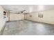 View of the garage with newly painted walls, an operational door, and multiple windows at 6682 Sw 106Th Ln, Ocala, FL 34476