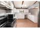 Updated kitchen featuring stainless steel appliances, wood beams, and white cabinetry at 6682 Sw 106Th Ln, Ocala, FL 34476