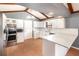 Bright kitchen with white cabinets, stainless steel appliances, and quartz countertops at 6682 Sw 106Th Ln, Ocala, FL 34476