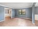 The living room features tile floors, neutral walls, and a large window that provides ample natural light at 6682 Sw 106Th Ln, Ocala, FL 34476