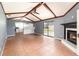 Spacious living room with tile flooring, fireplace, and wood beam ceilings at 6682 Sw 106Th Ln, Ocala, FL 34476