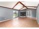 The living room features a brick fireplace, high ceilings with wooden beams, and tile floors at 6682 Sw 106Th Ln, Ocala, FL 34476