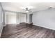Spacious main bedroom with wood flooring, ceiling fan, and double closets at 6682 Sw 106Th Ln, Ocala, FL 34476