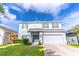 Two-story house with gray siding, gray shutters, and a two-car garage at 306 Mirasol Ln, Orlando, FL 32828