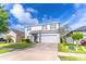 Two-story house with gray siding, gray shutters, and a two-car garage at 306 Mirasol Ln, Orlando, FL 32828