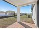 A covered back patio features brick pavers and an open yard at 527 Kennedy Dr, Lake Alfred, FL 33850