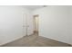 A bedroom featuring neutral carpet, two closets, and white walls creating a serene atmosphere at 527 Kennedy Dr, Lake Alfred, FL 33850