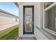 Close-up of a modern front door with glass panels providing a view into the bright, inviting interior at 527 Kennedy Dr, Lake Alfred, FL 33850