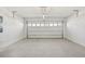 A clean two-car garage with white-painted walls and a concrete floor at 527 Kennedy Dr, Lake Alfred, FL 33850