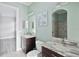 Elegant bathroom with double vanity, marble countertops, and a beautifully tiled shower, providing a luxurious experience at 5509 Meadow Hill Loop, Lady Lake, FL 32159