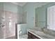 Well-lit bathroom with marble countertop, a large mirror, and walk-in shower at 5509 Meadow Hill Loop, Lady Lake, FL 32159