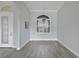 Elegant dining room featuring tile floors, decorative chandelier, a decorative window and a patterned front door at 5509 Meadow Hill Loop, Lady Lake, FL 32159