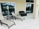 Relaxing outdoor patio featuring lounge chairs, table, and stylish wicker seating with a view of the pool at 5509 Meadow Hill Loop, Lady Lake, FL 32159