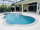 Sparkling pool with in-ground hot tub surrounded by a screened-in lanai and patio seating at 5509 Meadow Hill Loop, Lady Lake, FL 32159