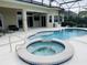 Beautiful pool and jacuzzi with plenty of patio space for entertaining at 5509 Meadow Hill Loop, Lady Lake, FL 32159