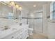 Modern bathroom showcasing dual sinks, sleek fixtures, and a glass-enclosed shower with decorative tile accents at 821 E Story Rd, Winter Garden, FL 34787