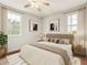 Comfortable bedroom with neutral tones, natural light from two windows, and modern decor at 821 E Story Rd, Winter Garden, FL 34787