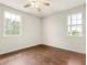 Empty bedroom with wood floors and two windows at 821 E Story Rd, Winter Garden, FL 34787