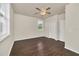 Bedroom featuring wood-look floors, a ceiling fan, and a window offering views of the outdoors at 821 E Story Rd, Winter Garden, FL 34787