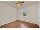 This bedroom features wood-look floors, a ceiling fan, and a sunlit window for a cozy atmosphere at 821 E Story Rd, Winter Garden, FL 34787