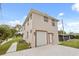 Two-story home featuring an attached garage, well-maintained lawn, and charming exterior details at 821 E Story Rd, Winter Garden, FL 34787