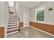 Bright foyer featuring a staircase, wood-look flooring and a decorative front door at 821 E Story Rd, Winter Garden, FL 34787