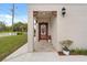 Inviting front entry with tiled porch, decorative accents, and well-manicured landscaping at 821 E Story Rd, Winter Garden, FL 34787