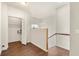 Bright hallway featuring wood floors, stairs, and a laundry closet at 821 E Story Rd, Winter Garden, FL 34787