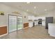 Open-concept kitchen with stainless steel appliances, light countertops, and sliding door at 821 E Story Rd, Winter Garden, FL 34787