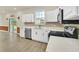 Modern kitchen with white cabinetry, stainless steel appliances, and quartz countertops at 821 E Story Rd, Winter Garden, FL 34787