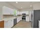 Well-lit kitchen featuring modern appliances, white cabinets, and elegant countertops at 821 E Story Rd, Winter Garden, FL 34787