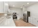 Stylish kitchen with stainless steel appliances, white cabinets, quartz countertops, and wood flooring at 821 E Story Rd, Winter Garden, FL 34787