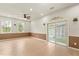 Sunlit living room with wood floors, ceiling fan, and slider to a bright, enclosed lanai at 821 E Story Rd, Winter Garden, FL 34787