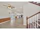 Open-concept living room with stairs, sliding door, and kitchen in the background at 821 E Story Rd, Winter Garden, FL 34787