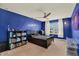 Blue bedroom with carpeted floor, ceiling fan, and natural light from the window at 5232 Villa Rosa Ave, Saint Cloud, FL 34771