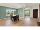 Bright dining room featuring large windows, tray ceilings, decorative lighting and tile floors at 5232 Villa Rosa Ave, Saint Cloud, FL 34771