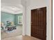 Inviting entryway with wood door, tile floors, and a view into the sitting room at 5232 Villa Rosa Ave, Saint Cloud, FL 34771