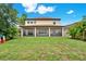 Expansive backyard featuring a screened porch and lush landscaping perfect for outdoor entertaining and relaxation at 5232 Villa Rosa Ave, St Cloud, FL 34771